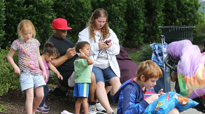 William Lavelle Daniels, his wife April, and their children join hundreds of other local residents being evacuated from the city at the Savannah Civic Center Saturday. Curtis Compton/ccompton@ajc.com