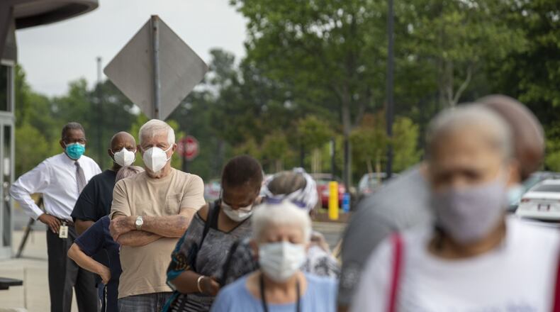 Lawrenceville, Georgia - Voters wearing face masks strand in line outside of the Gwinnett County Voter Registration and Elections Office in order to participate in early voting in Lawrenceville, Monday, May 18, 2020. Early voting began May 18 and will last three-weeks until June 5. Georgia’s election day is Tuesday, June 9. (ALYSSA POINTER / ALYSSA.POINTER@AJC.COM)