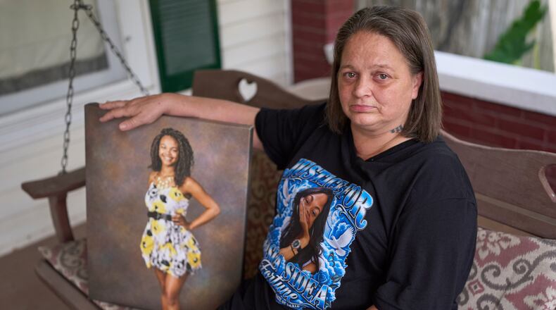 Christy Spivey poses with a portrait of her late daughter, Tasia Fortune, on Tuesday, Sept. 8, 2026, in Marion, Ky. (AP Photo/George Walker IV)