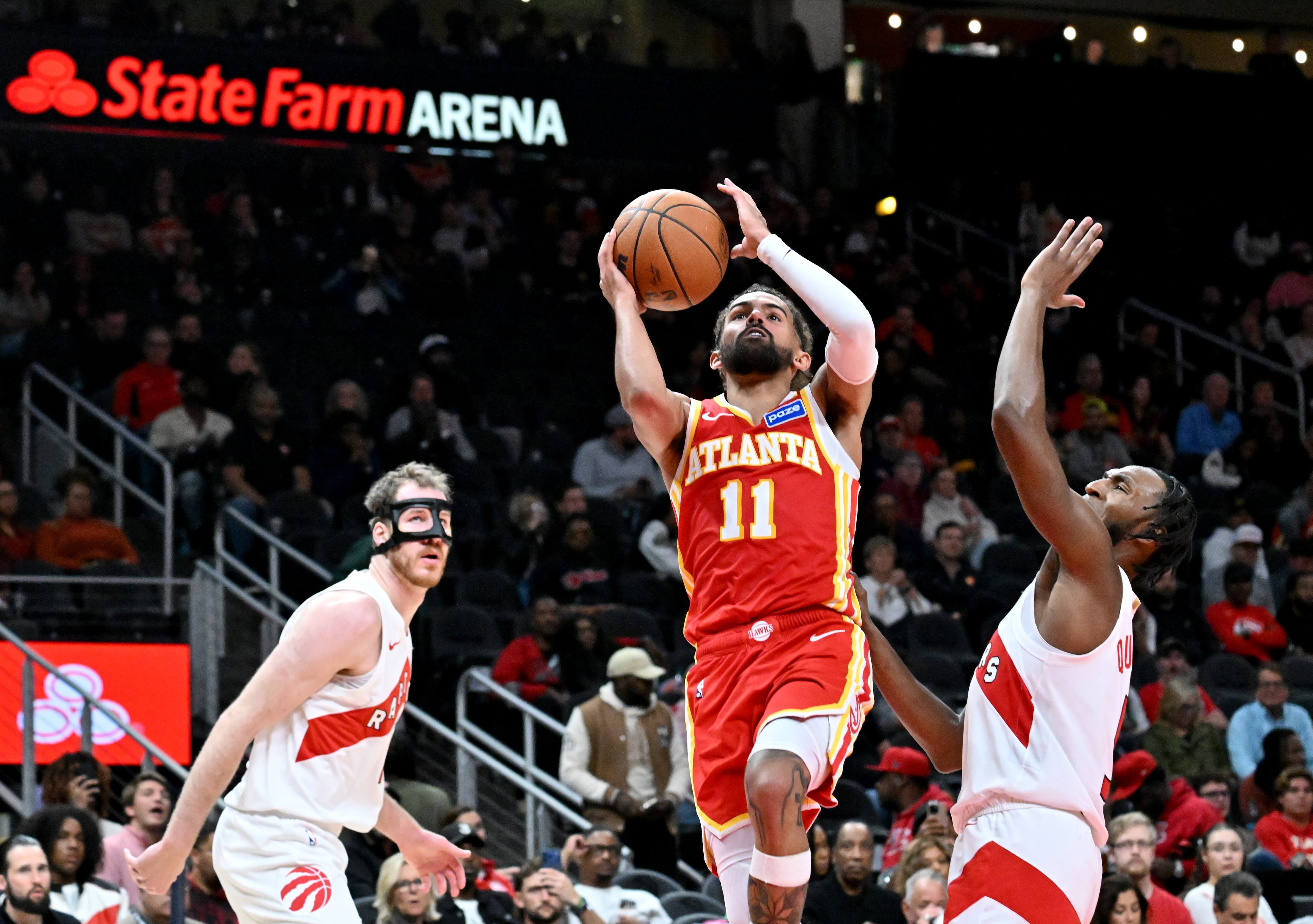 Atlanta Hawks guard Trae Young (11) goes to the basket for the shot during the second half in the home opener at State Farm Arena, Thursday, October 22, 2025, in Atlanta. Toronto Raptors won 138-118 over Atlanta Hawks. (Hyosub Shin / AJC)