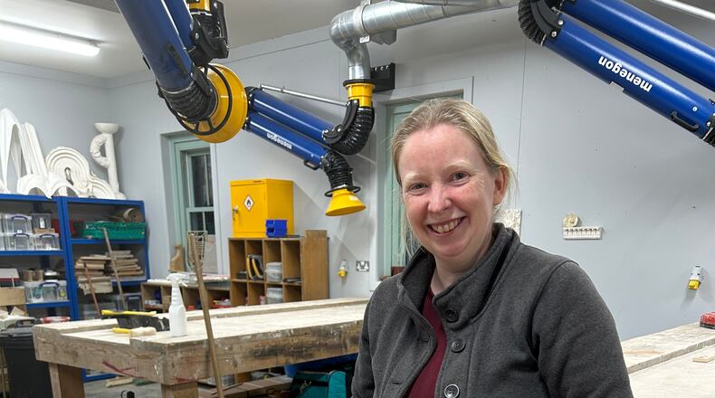 Jennie Regan stands beside the stone she carved with an inscription from a Scottish fairy tale at Dumfries House in Cumnock, Scotland, Nov. 26, 2025. (AP Photo/Danica Kirka)