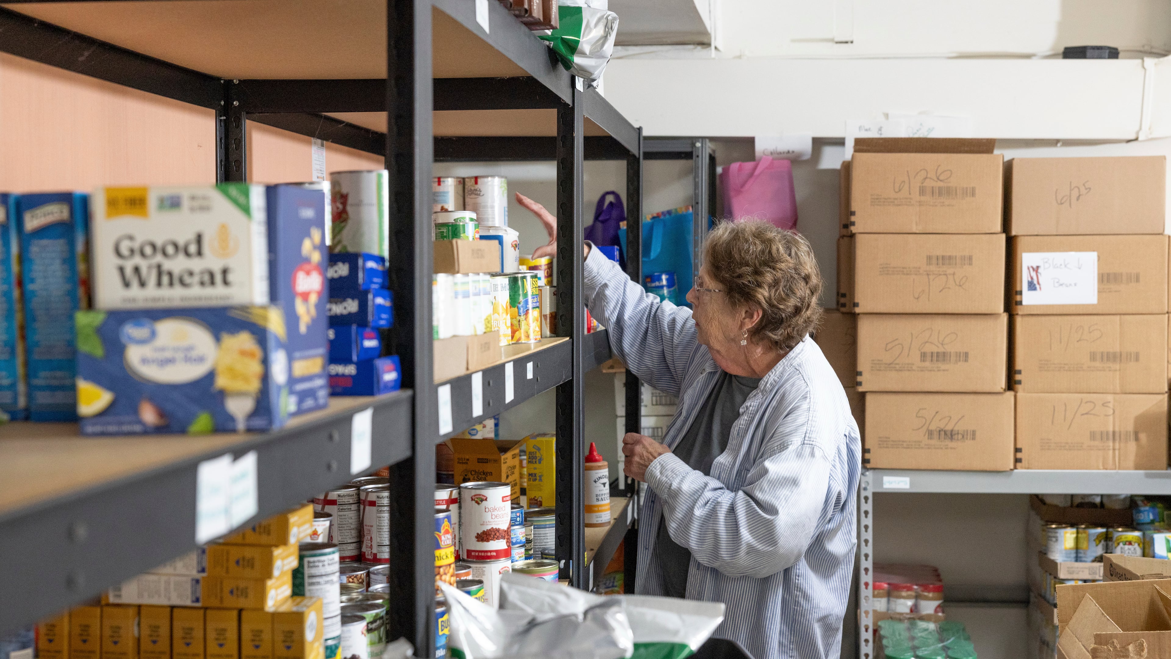 Phylis Allen organizes supplies at Neighbor's Cupboard in Winterport, Maine, on Tuesday, Aug. 26, 2025, a food pantry that she has helped run for the past 17 years. (Katherine Emery/The Maine Monitor via AP)