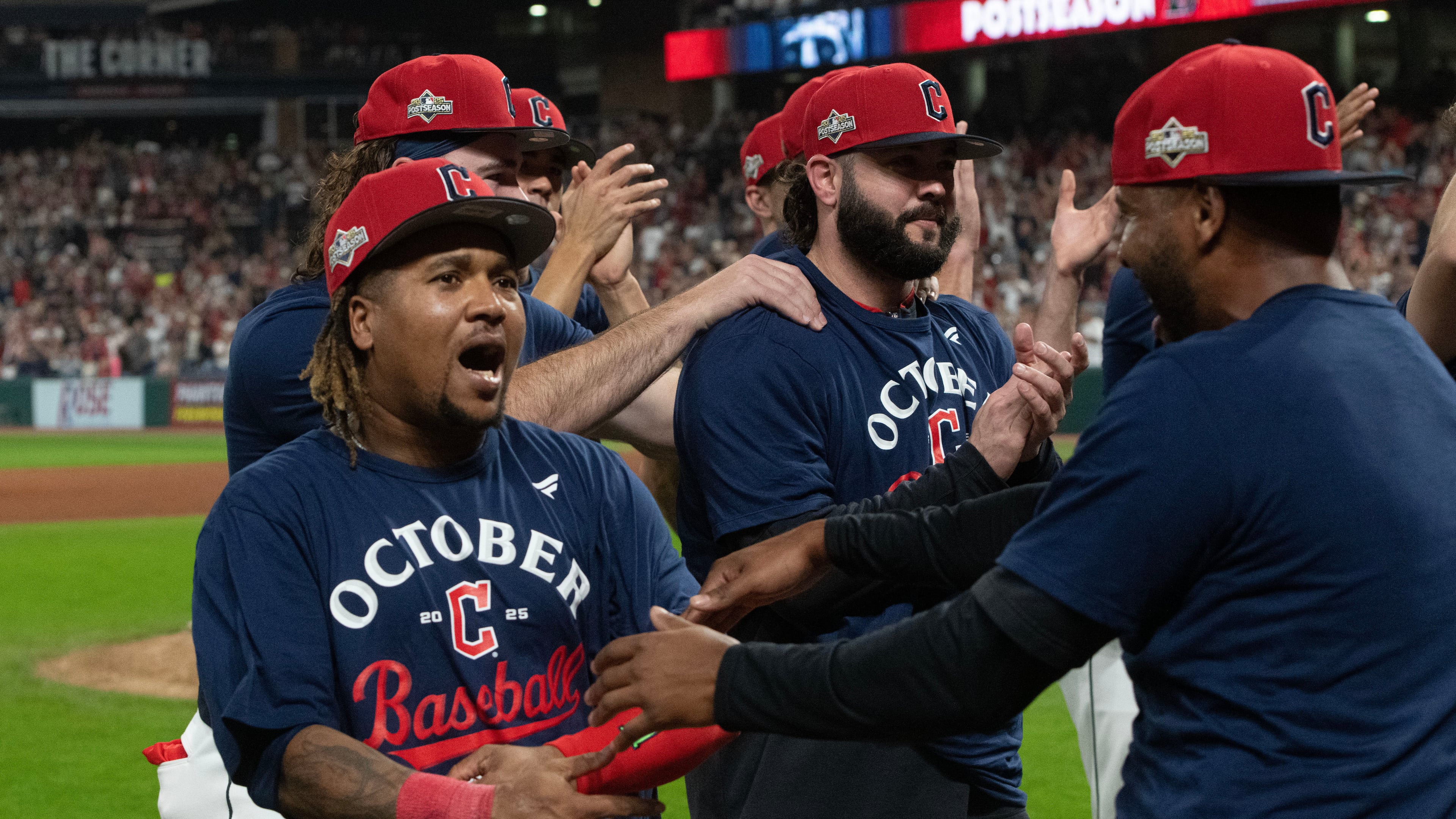 Cleveland Guardians' Jose Ramirez, left, celebrates with his teammates after securing an American League playoff spot at the end of a baseball game against the Texas Rangers, Saturday, Sept. 27, 2025, in Cleveland. (AP Photo/Phil Long)