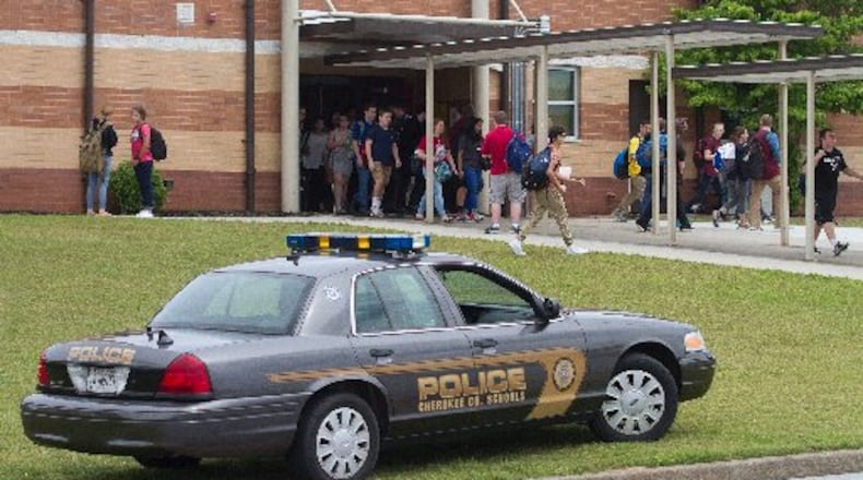 Students leave Woodstock High School on Friday after a school lockdown was lifted. STEVE SCHAEFER / SPECIAL TO THE AJC