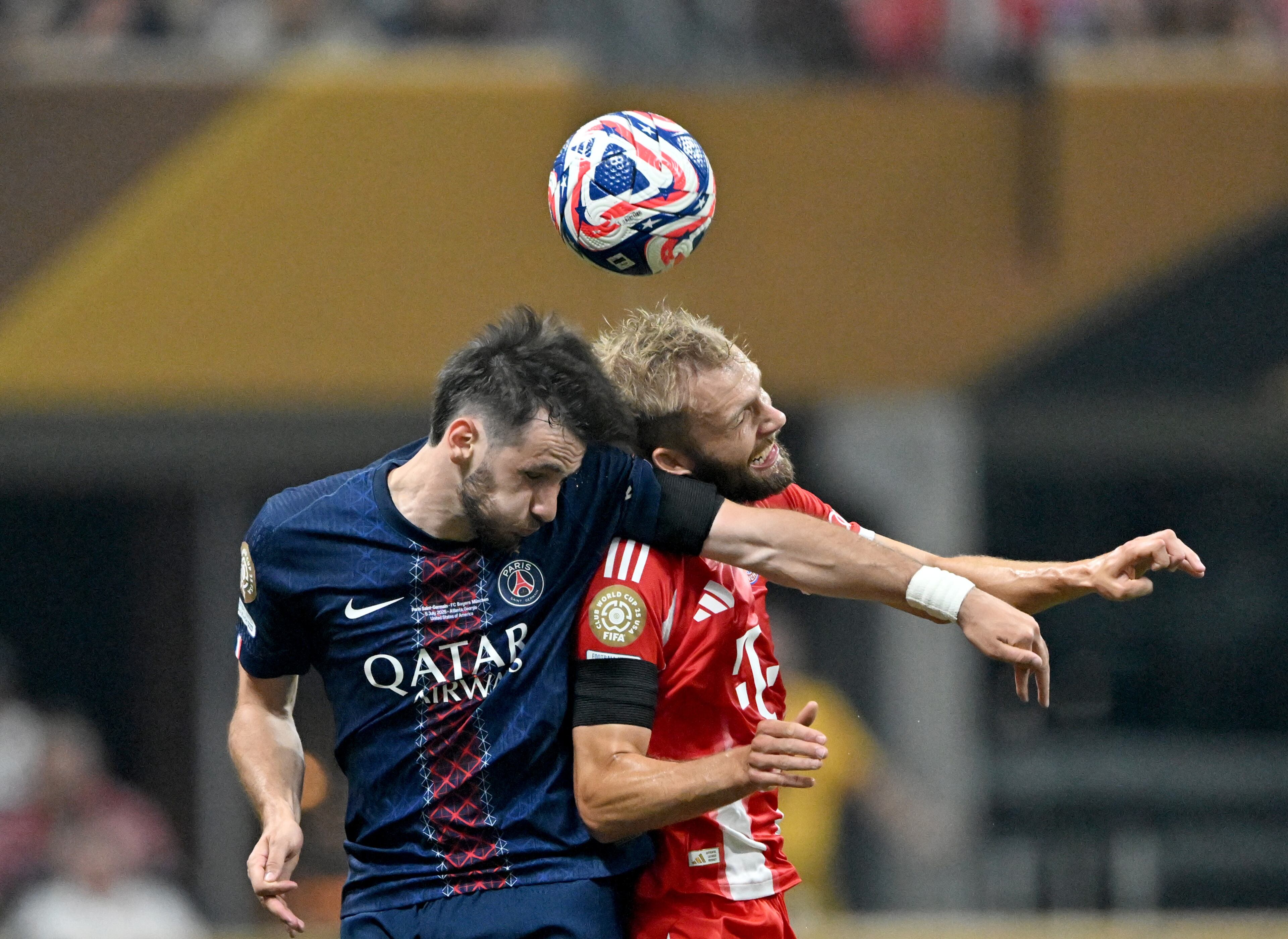 Paris Saint-Germain forward Khvicha Kvaratskhelia (7) Bayern Munich midfielder Konrad Laimer (27) collide on a header during the first half in Club World Cup quarterfinals match at Mercedes-Benz Stadium, Saturday, July 5, 2025, in Atlanta. Paris Saint-Germain won 2-0 over Bayern Munich. (Hyosub Shin / AJC)
