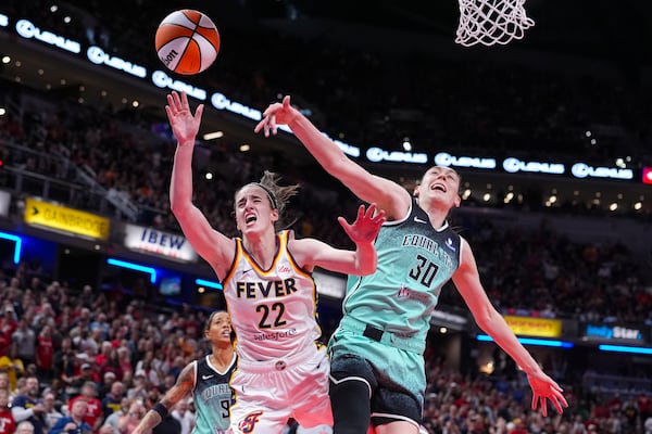 Indiana Fever guard Caitlin Clark (22) reacts after being hit by New York Liberty forward Breanna Stewart (30) in the second half of a WNBA basketball game in Indianapolis, Saturday, May 24, 2025. (AP Photo/Michael Conroy)