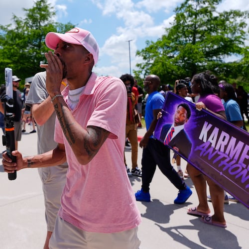 A person walks around announcing the guilty verdict in the Karmelo Anthony trial in front of the Collin County courthouse, Tuesday, June 9, 2026, in McKinney, Texas. (AP Photo/Tony Gutierrez)