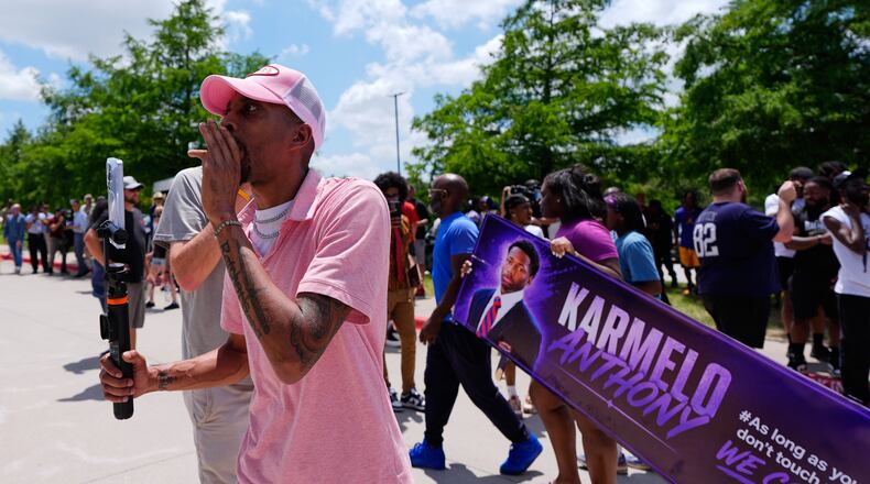 A person walks around announcing the guilty verdict in the Karmelo Anthony trial in front of the Collin County courthouse, Tuesday, June 9, 2026, in McKinney, Texas. (AP Photo/Tony Gutierrez)