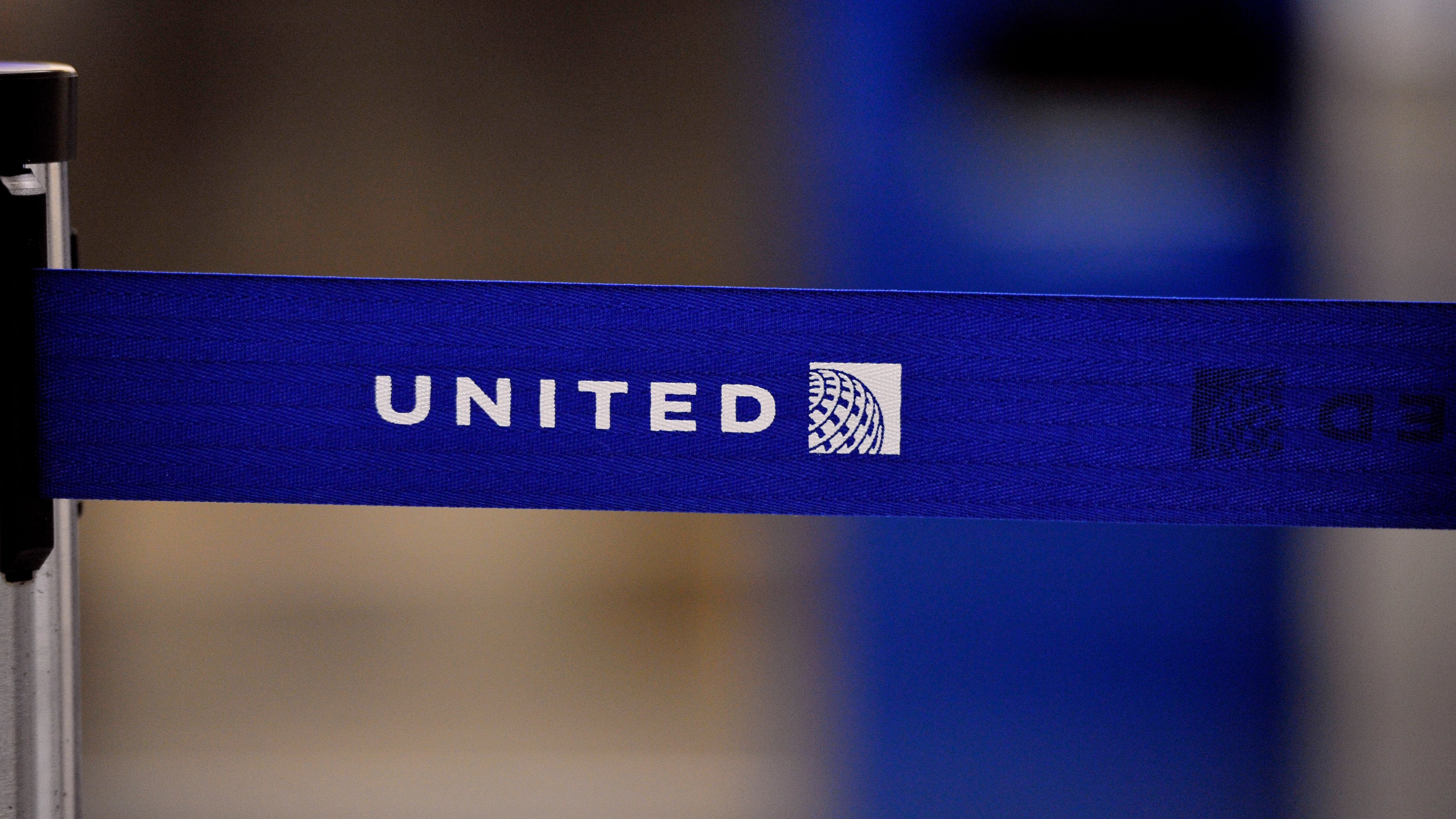 FILE - The United Airlines logo can be seen on a rope line at O'Hare International Airport, May 17, 2011. (AP Photo/Brian Kersey, File)