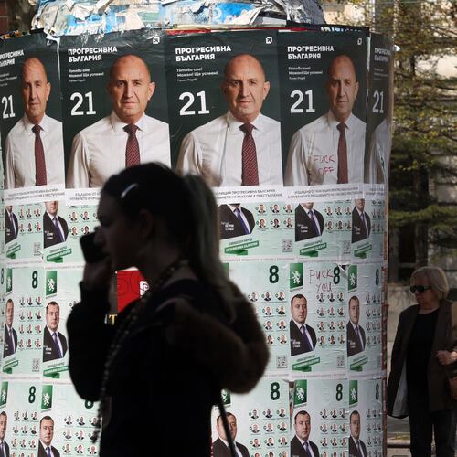 People pass posters of former president Rumen Radev, after Bulgaria's parliamentary election, in Sofia, Monday, April 20, 2026. (AP Photo/Valentina Petrova)
