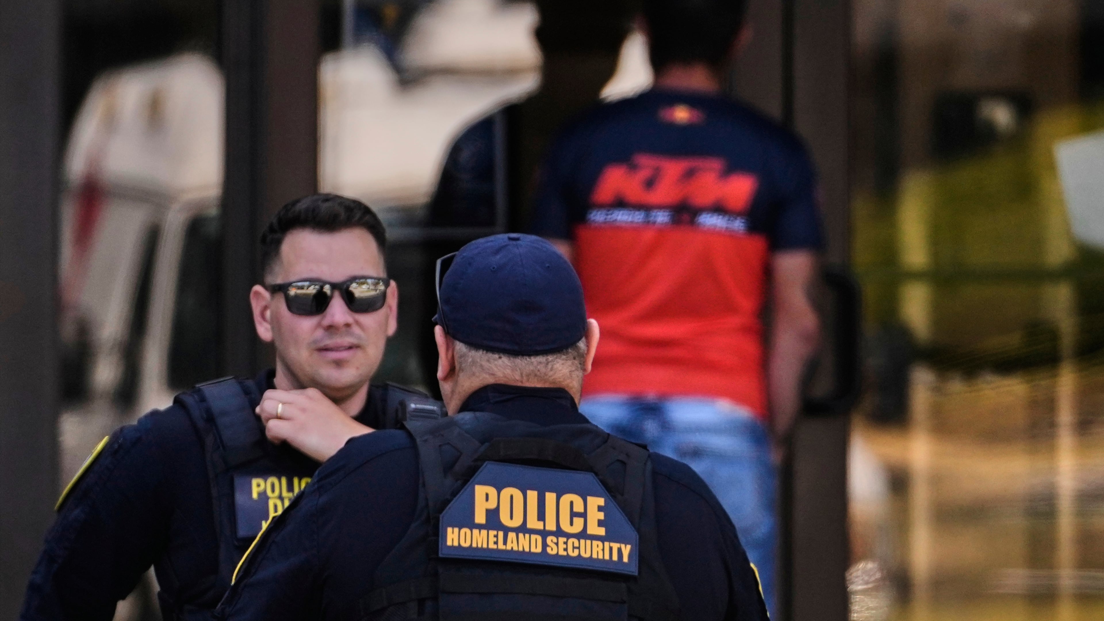 Department of Homeland Security police officers are stationed at the front door of the U.S. Immigration and Customs Enforcement regional field office, Tuesday, Sept. 16, 2025, in Burlington, Mass. (AP Photo/Charles Krupa)