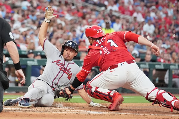Atlanta Braves' Drake Baldwin, left, is tagged out at home by St. Louis Cardinals catcher Pedro Pages during the third inning of a baseball game Friday, July 11, 2025, in St. Louis. (AP Photo/Jeff Roberson)