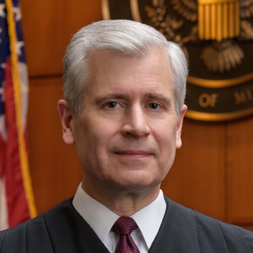 This undated photo provided by the U.S. District Court of Minnesota Thursday, Jan. 29, 2026, shows Chief U.S. District Judge Patrick Schiltz posing for a portrait in his Minneapolis courtroom. (U.S. District Court of Minnesota via AP)