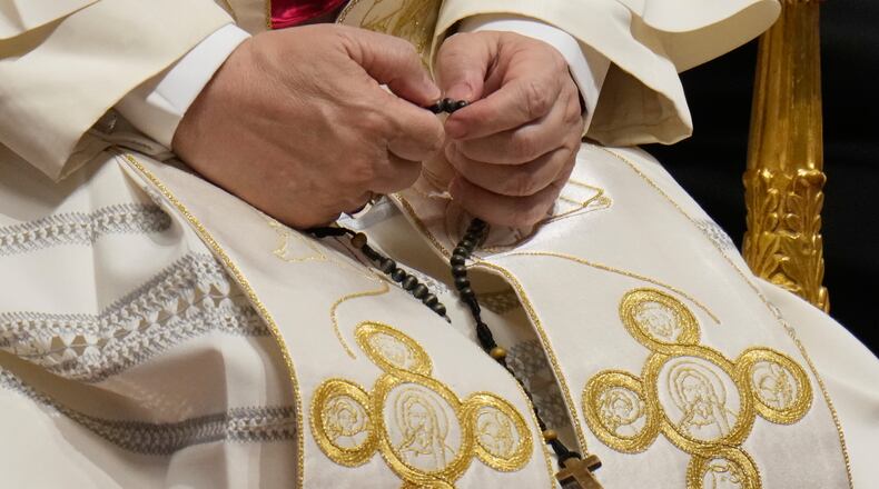 Pope Leo XIV holds a rosary as he leads a vigil for peace inside St. Peter's Basilica at the Vatican, Saturday, April 11, 2026. (AP Photo/Gregorio Borgia)