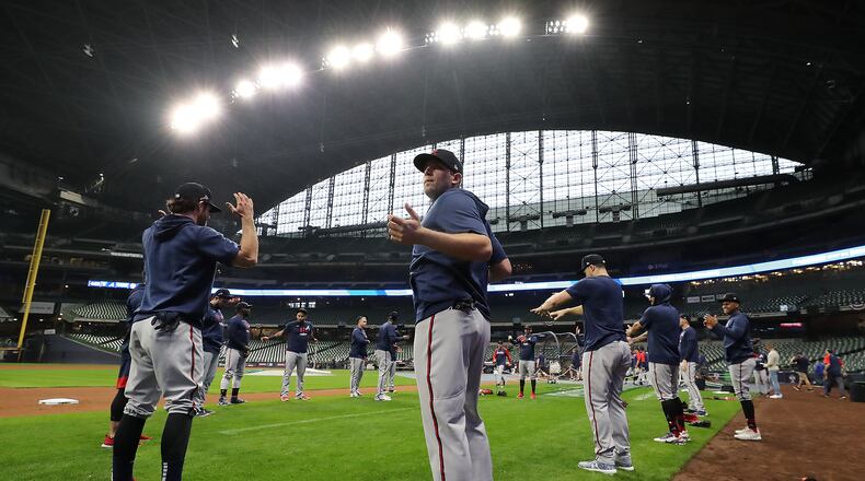 100721 MILWAUKEE: Atlanta Braves third baseman Austin Riley (center) takes in the stadium as the team loosens up for practice inside American Family Field preparing for the opening game of the National League Division Series against the Milwaukee Brewers on Thursday, Oct. 7, 2021, in Milwaukee. “Curtis Compton / Curtis.Compton@ajc.com”
