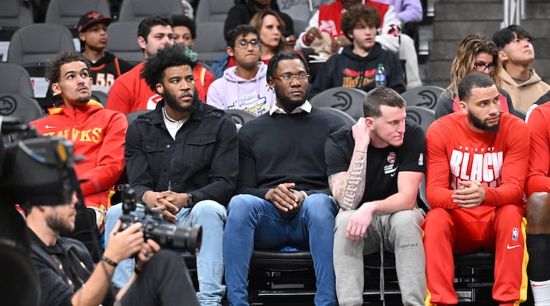 Saddiq Bey (from left), Bruno Fernando and Garrison Mathews sit on the bench during the first half in an NBA basketball game at State Farm Arena, Saturday, Feb. 11, 2023, in Atlanta. Atlanta Hawks won 125-106 over San Antonio Spurs. (Hyosub Shin / Hyosub.Shin@ajc.com)