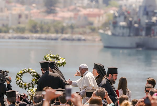 FILE - Pope Francis, center, Ecumenical Patriarch Bartholomew I, left, and Archbishop of Athens Ieronymos II, toss floral wreaths into the sea on the Greek island of Lesbos, April 16, 2016. (AP Photo/Petros Giannakouris, File)