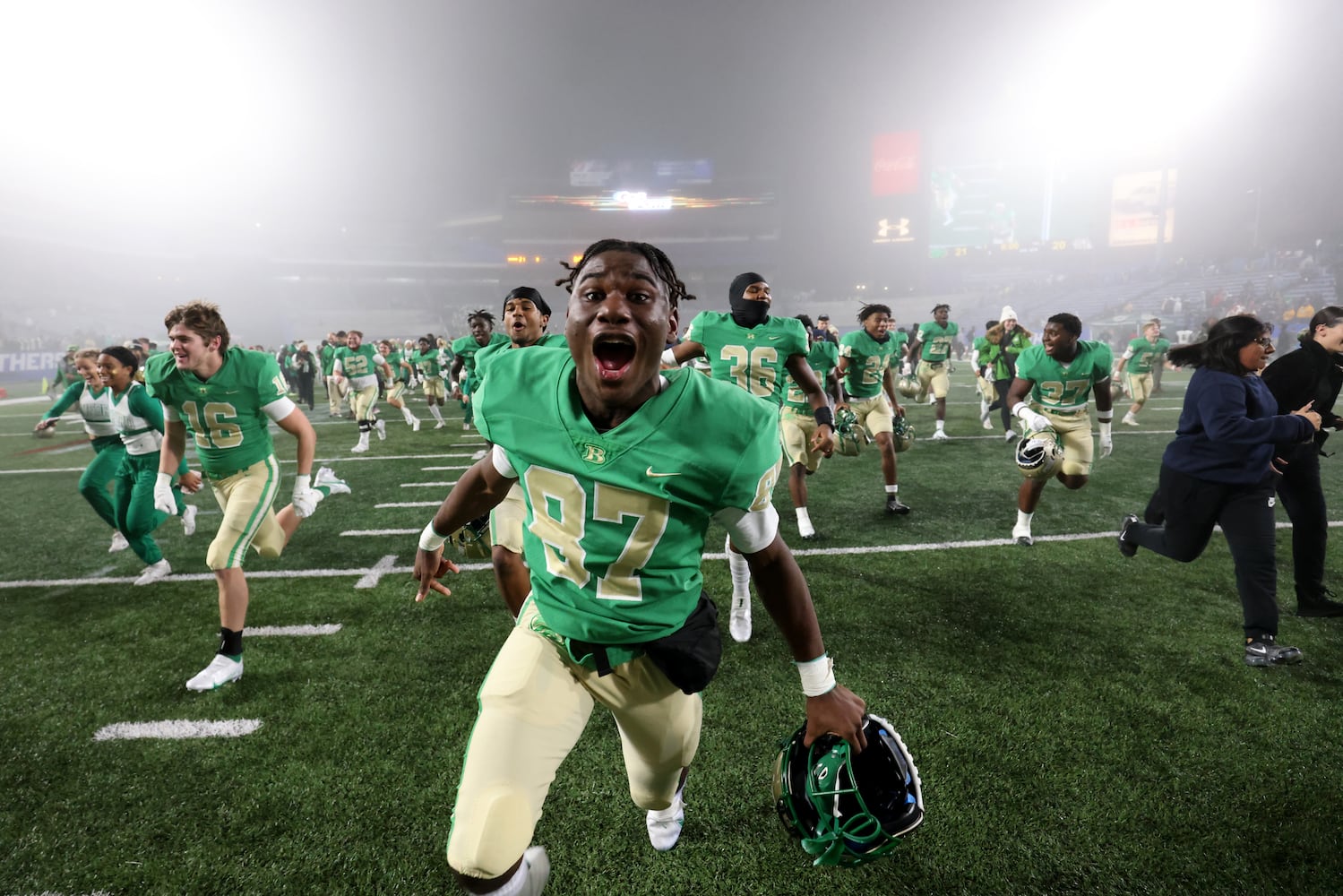 December 10, 2021 - Atlanta, Ga: BufordÕs Javias Robinson (87) and others run toward their student section as they celebrate their 21-20 victory over Langston Hughes during the Class 6A state title football game at Georgia State Center Parc Stadium Friday, December 10, 2021, Atlanta. JASON GETZ FOR THE ATLANTA JOURNAL-CONSTITUTION