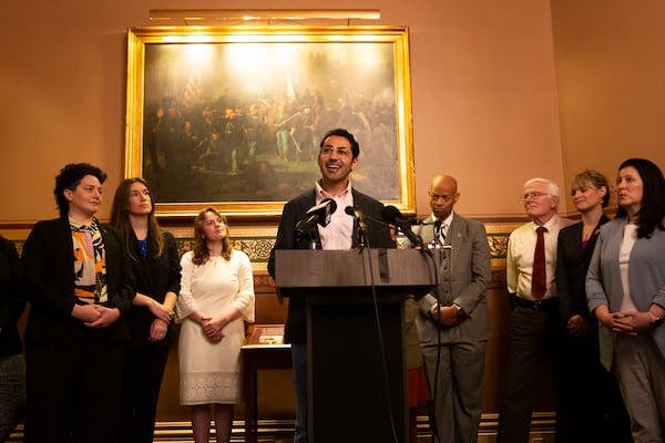 Mohsen Mahdawi, center, speaks during a press conference announcing the launch of the Vermont Immigration Legal Defense Fund in the Cedar Creek Reception Room at the Vermont State House on Thursday, May 8, 2025, in Montpelier, Vt. (AP Photo/Alex Driehaus)
