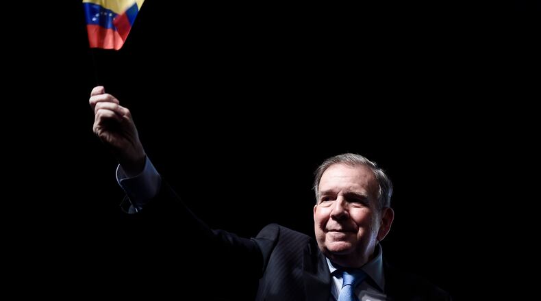 FILE - Venezuela's opposition leader Edmundo Gonzalez waves a Venezuelan flag during a meeting with supporters in Panama City, Jan. 8, 2025. (AP Photo/Agustin Herrera, File)