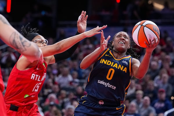 Indiana Fever guard Kelsey Mitchell (0) shoots in front of Atlanta Dream guard Allisha Gray (15) in the first half of a WNBA basketball game in Indianapolis, Tuesday, May 20, 2025. (AP Photo/Michael Conroy)