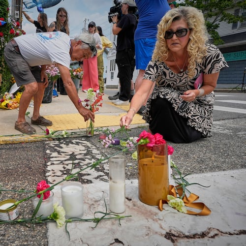 Mourners place flowers and candles in Biddeford, Maine, Wednesday, July 15 2026, near the blood-stained pavement where Johan Sebastián Durán Guerrero was pulled from his car on Monday by U.S. Immigration and Customs Enforcement agents. (AP Photo/Robert F. Bukaty)