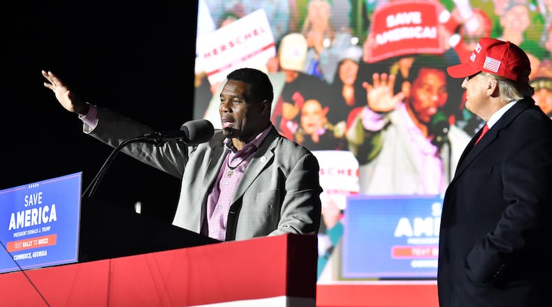 In this photo from March 26, 2022, Herschel Walker, the front-runner for the party’s U.S. Senate nominee, speaks as former President Donald Trump looks during a rally for Georgia GOP candidates at Banks County Dragway in Commerce. (Hyosub Shin/The Atlanta Journal-Constitution/TNS)