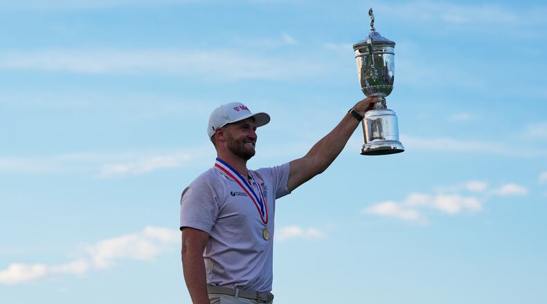 Wyndham Clark holds the trophy after winning the U.S. Open golf tournament at Shinnecock Hills Golf Club in Southampton, N.Y., Sunday, June 21, 2026. (AP Photo/Seth Wenig)