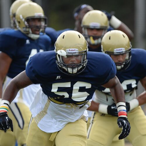 Defensive end Anthony Williams (center) is now the football coach at Locust Grove. (Johnny Crawford/AJC)