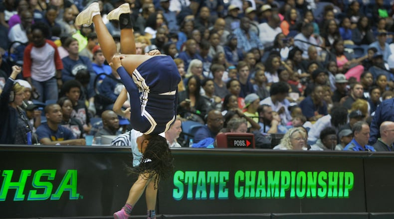 Norcross Blue Devils cheerleader does a flip during halftime of the Class AAAAAA state championship at the Macon Coliseum, Saturday, March 7, 2015.