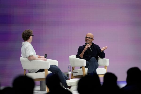 Microsoft Chairman and CEO Satya Nadella, right, speaks with Meta Founder and CEO Mark Zuckerberg at LlamaCon 2025, an AI developer conference, in Menlo Park, Calif., Tuesday, April 29, 2025. (AP Photo/Jeff Chiu)