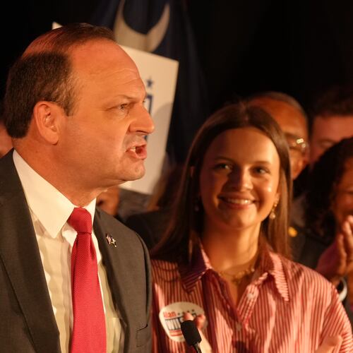 As his daughter, Anna Grace, looks on, South Carolina Attorney General Alan Wilson, left, speaks to supporters as he celebrates his GOP gubernatorial runoff victory in a hotel ballroom on Tuesday, June 23, 2026, in Columbia, S.C. (AP Photo/Meg Kinnard)
