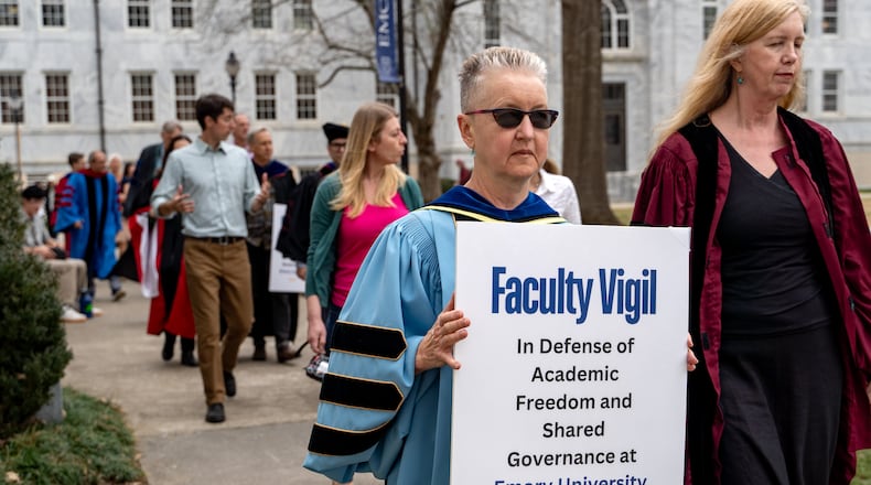 Emory professor Lynne Huffer (center) holds a sign during a protest on Wednesday, February 5, 2025 (Ben Hendren for the Atlanta Journal-Constitution)