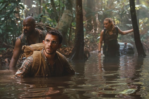 This image released by Universal Pictures and Amblin Entertainment shows, from left, Bechir Sylvain, Jonathan Bailey, and Scarlett Johansson in a scene from " Jurassic World Rebirth." (Jasin Boland/Universal Pictures and Amblin Entertainment via AP)