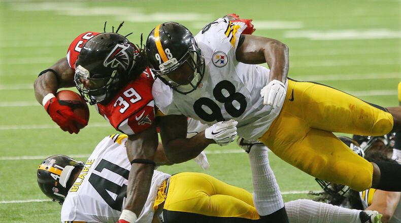 121414 ATLANTA: Steelers linebacker Vince Williams (right) and cornerback Antwon Blake tackle Falcons running back Steven Jackson short of the endzone stopping a drive in the red zone during the second half in a football game on Sunday, Dec. 14, 2014, in Atlanta. CURTIS COMPTON / CCOMPTON@AJC.COM
