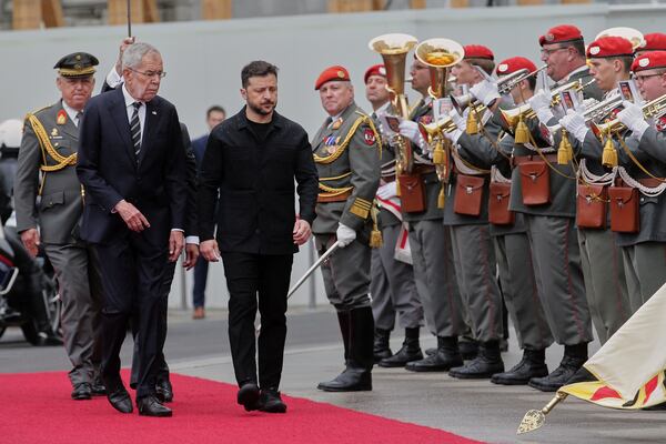 Ukraine's President Volodymyr Zelenskyy, right, and Austrian President Alexander van Der Bellen walk past the honour guard in Vienna, Austria, Monday, June 16, 2025. (AP Photo/Heinz-Peter Bader)