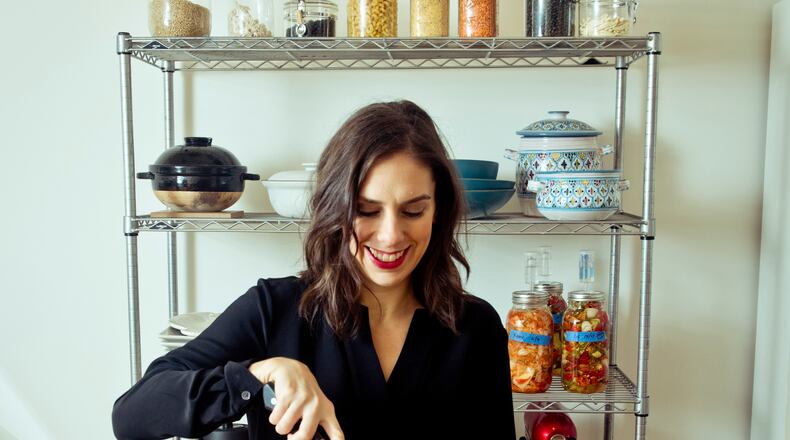 Danielle Gould, founder of Food & Tech Connect, with the four-inch-thick, 80-pound rock maple John Boos chopping block that dominates her kitchen, in New York, Oct. 21, 2015. Gould hauled the block home in 2012 after it was used for a hog-butchering demonstration at a Food & Tech Connect-organized event. Funny thing though, Gould is a vegetarian.