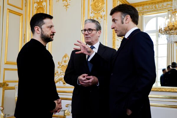 Ukraine's President Volodymyr Zelenskyy, left, French President Emmanuel Macron, right, and Britain's Prime Minister Keir Starmer speak during a trilateral meeting on the sidelines of a summit for "coalition of the willing" at the Elysee Palace, Thursday, March 27, 2025. (Ludovic Marin, Pool via AP)