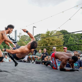Stunt Marshall, left, applies a bodyslam to Apollo Prince during a wrestling match at New Realm Brewing on Sunday, August 31, 2025, in Atlanta. (Miguel Martinez/ AJC)