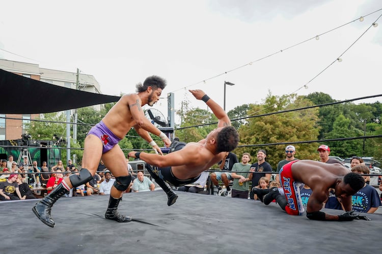 Stunt Marshall, left, applies a bodyslam to Apollo Prince during a wrestling match at New Realm Brewing on Sunday, August 31, 2025, in Atlanta. (Miguel Martinez/ AJC)