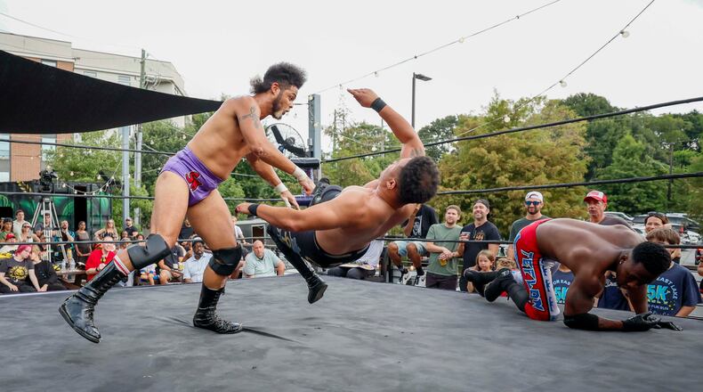 Stunt Marshall, left, applies a bodyslam to Apollo Prince during a wrestling match at New Realm Brewing on Sunday, August 31, 2025, in Atlanta. (Miguel Martinez/ AJC)