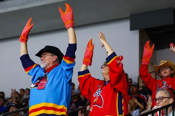 Athens Rock Lobsters fans celebrate a goal  by waving their lobster claws.  (Colin Hubbard for the AJC) 