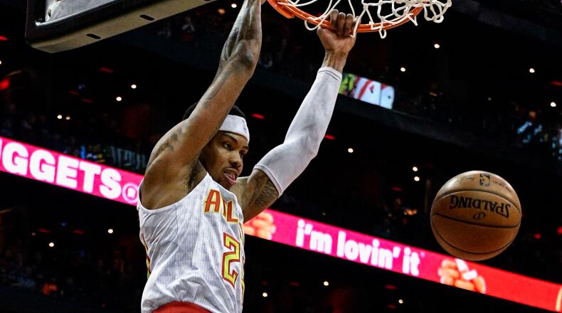 Atlanta Hawks forward Kent Bazemore (24) dunks in front of Orlando Magic guard Evan Fournier (10) during the first half of an NBA basketball game, Saturday, Feb. 4, 2017, in Atlanta. (AP Photo/John Amis)
