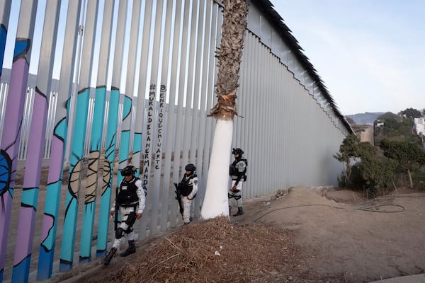 FILE - Members of the Mexican National Guard patrol along the border wall separating Mexico and the United States, in Tijuana, Jan. 20, 2025. (AP Photo/Gregory Bull, File)
