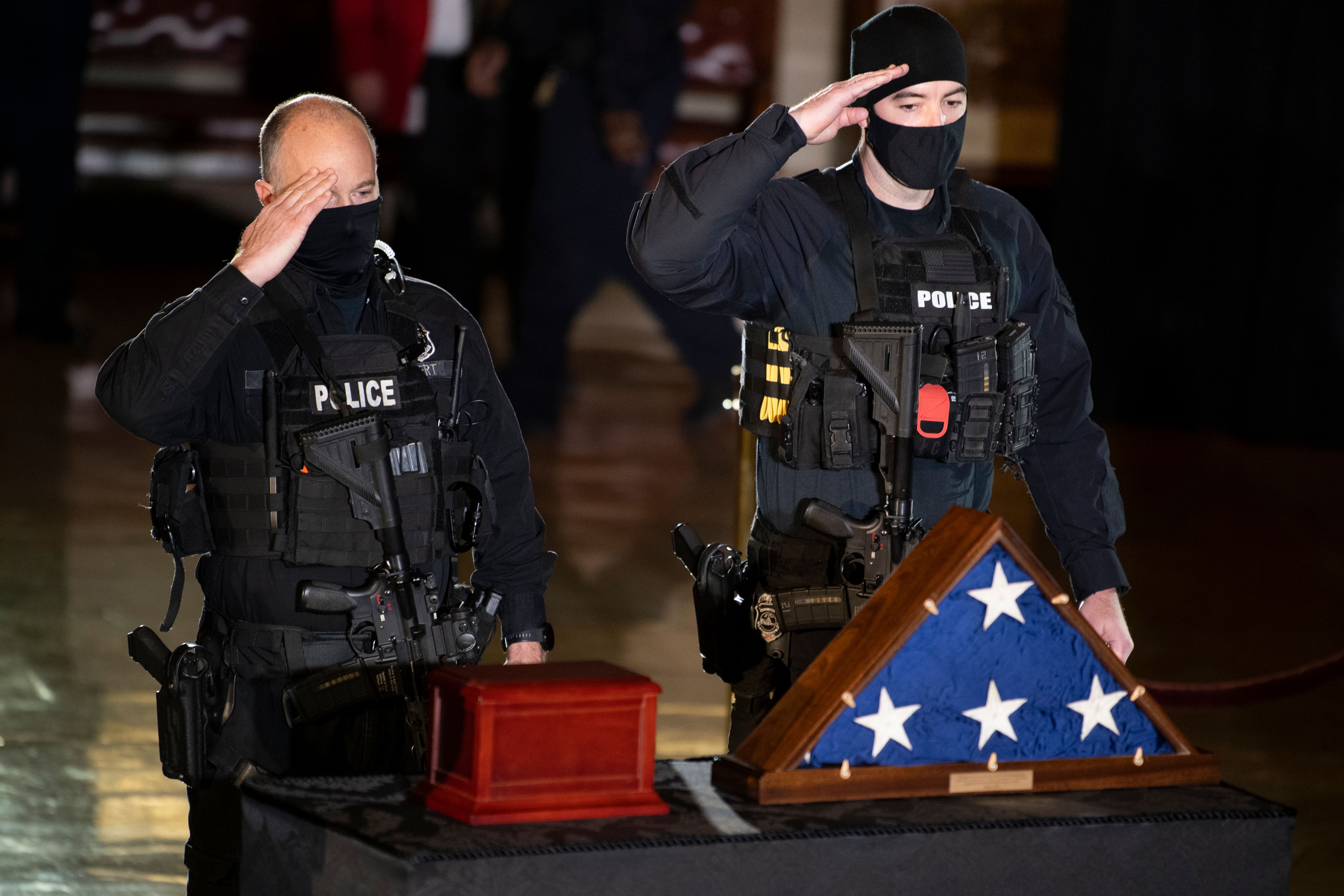 Members of the Capitol Police pay respects to the remains of U.S. Capitol Police Officer Brian Sicknick as he lies in honor in the Rotunda of the U.S. Capitol in February. Sicknick died after being injured in the Jan. 6 attack by rioters supporting then-President Donald Trump. (Brendan Smialowski/Pool/AFP via Getty Images/TNS)