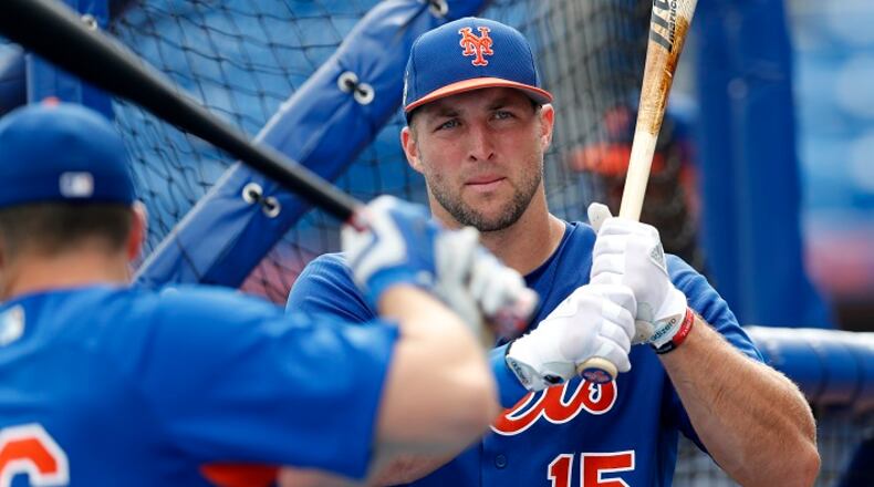 FILE - In this March 13, 2017, file photo, New York Mets' Tim Tebow (15) takes batting practice before a spring training baseball game against the Miami Marlins in Port St. Lucie, Fla. Tebow will be at the Mets spring training as a non-roster invite. The former NFL quarterback and 2007 Heisman Trophy winner batted .226 with eight homers, 52 RBIs and 126 strikeouts in 126 games last year at two levels of Class-A ball.  (AP Photo/John Bazemore, File)