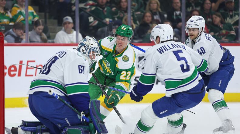 Minnesota Wild right wing Danila Yurov (22) shoots the puck against Vancouver Canucks goaltender Nikita Tolopilo (60) during the first period of an NHL hockey game Thursday, April 2, 2026, in St. Paul, Minn. (AP Photo/Matt Krohn)