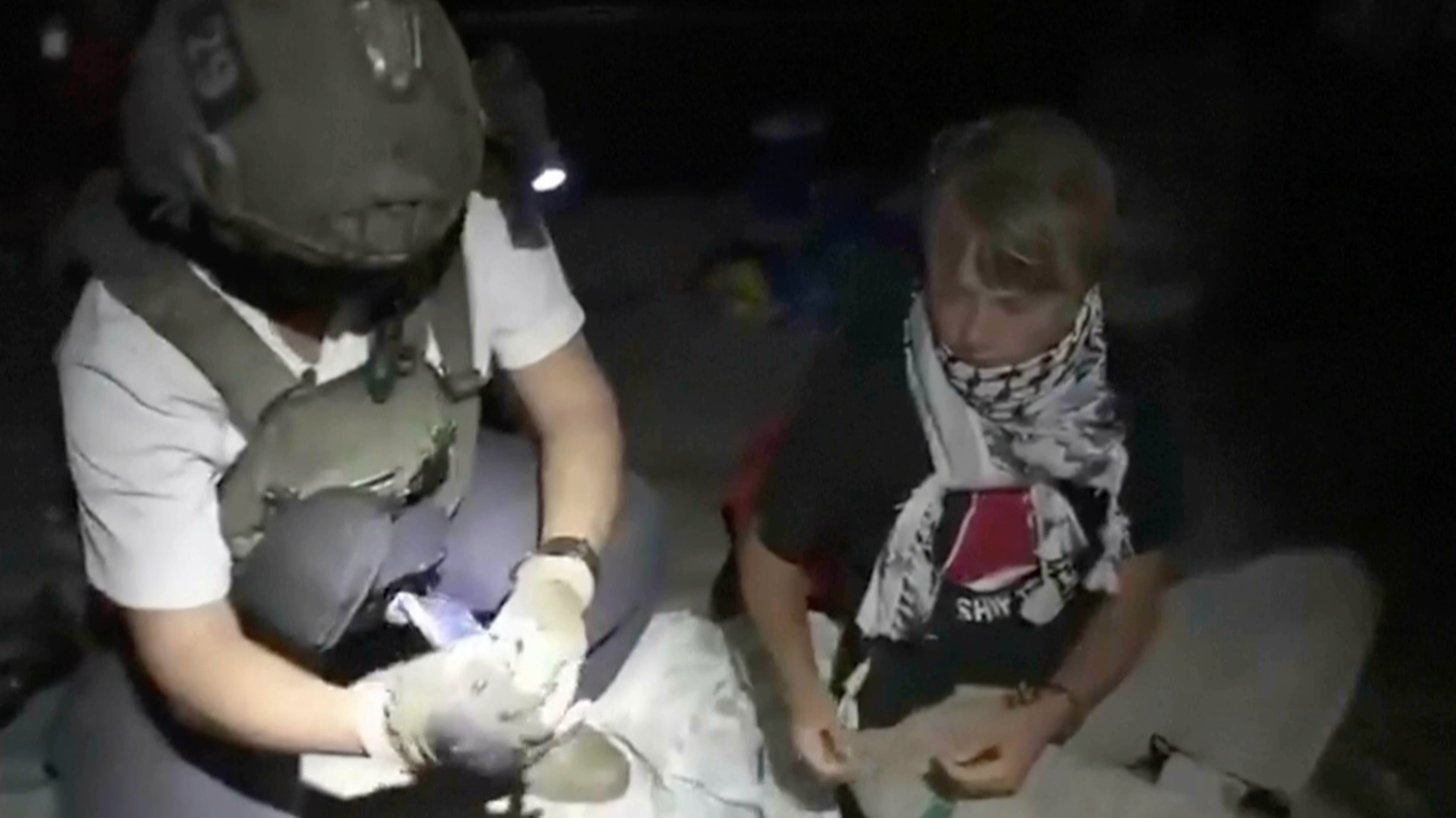 This image taken from video released by the Israeli Foreign Ministry claims to show activist Greta Thunberg, right, as she is removed after the Israeli navy intercepted the Global Sumud Flotilla carrying humanitarian aid towards Gaza on Wednesday, Oct. 1, 2025. (Israeli Foreign Ministry via AP)