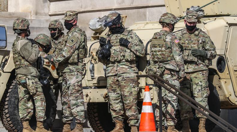 The Georgia National Guard, the State Patrol and other law enforcement agencies surrounded the Georgia Capitol building again on Wednesday, Jan. 20, 2021, with military equipment. Federal education officials are proposing new regulations to crack down on for-profit colleges they say recruit veterans with deceptive claims about degrees and job placement. (John Spink / John.Spink@ajc.com)