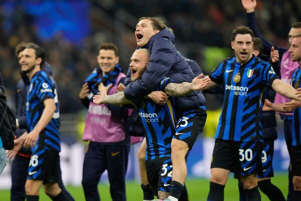 Inter Milan players celebrate at the end of the Champions League quarterfinal second leg soccer match between Inter Milan and Bayern Munich at the San Siro stadium in Milan, Italy, Wednesday, April 16, 2025. (AP Photo/Luca Bruno)